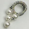 Detailed shot of luxurious pearl rhinestone brooch with elegant black silver spring design. - Spiral Drop Style (Z-738)