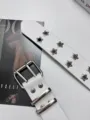 Stylish white leather punk belt featuring double star grommets and silver double prong buckle. - White