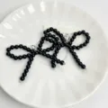 Black pearl beaded bow shoe charm accessory for stylish sneakers and footwear decoration. - Black Single Layer Bowknot