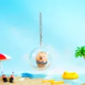 Süßer Wasserschwein Gachapon Schlüsselanhänger in transparenter Kapsel Strand Stil - Schokoladen-Stil
