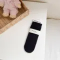 Solid color ribbed cotton mid-tube women socks in black, comfortable daily wear style. - One Size with Heel / Black