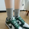 Detail shot of grey ribbed mid-tube stacking socks paired with stylish green sneakers. - One Size / Plain Knit - Light Gray