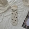 Women's breathable mid-tube slouch socks featuring cute black bows, perfect for spring and summer. - One Size / Pearl White - All-over Bow Print