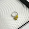 Close-up view of the handmade wire-wrapped natural crystal ring featuring a vibrant yellow raw stone. - Style E (X-456)