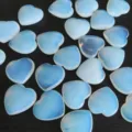Beautiful 2cm heart-shaped opalite crystal stones featuring a glowing blue translucency - Opal (Synthetic)