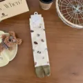 Cream split-toe socks with cute cartoon puppy patterns, cozy mid-tube daily wear style. - One Size / All-over Dog Print Style