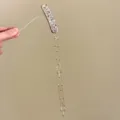 Exquisite rhinestone tassel hair clip detail view with sparkling crystals and delicate chains. - White Gold Tassel Hair Clip (Single) (Z-1240)