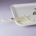 White plastic body piercing clamp tool for professional body jewelry insertion and piercing. - Disposable Triangle Open Forceps