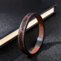 Detail view of men's retro feather embossed leather bracelet with black magnetic clasp. - Brown Leather Embossed Feather / 19cm