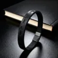 Close-up view of the black leather bracelet featuring embossed cross designs and clasp. - Black Leather Cross Style / 19cm