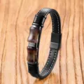 Close-up detail of a retro black leather bracelet featuring stainless steel clasp and crystals. - Purple Crystal