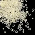 Close-up detail of translucent matte hollow star flower sequin nail art DIY craft pieces. - 15g Bag / Light Yellow