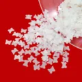 Detailed shot of matte white hollow butterfly sequins for DIY craft, nail art and resin filling. - White