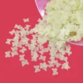 Close-up detail of matte hollow butterfly sequins for DIY crafts, nail art and resin filler. - Light Yellow