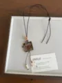 Detail view of the retro coconut shell cat necklace with wooden beads and cute plaid bow. - Coconut Shell Cat Bow Tassel Style (XL5465B)