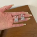 Exquisite silver padlock earrings detail, sparkling cubic zirconia paved design, elegant jewelry. - Silver Mini Lock Stud Style (EH3242)