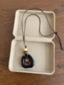 Close-up detail of the vintage ethnic style pendant necklace with adjustable brown cord and beads. - Brown Irregular Double Ring Style (XL5537A)