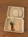 Detailed view of vintage bohemian style beaded necklace with charms and paper box packaging. - Square Tassel Style (XL5339)