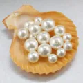 Close-up of white imitation pearl loose beads with holes, perfect for DIY jewelry making. - 8mm / Creamy White