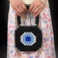 Handmade beaded square handbag with evil eye pattern, stylish black woven tote bag for women - Multicolor