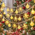 Detailed view of warm LED Christmas string lights featuring snowflake and bubble ball hanging ornaments. - 1.5m 10LED Battery