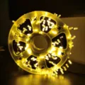 Warm yellow LED crystal string lights wound on a yellow spool for home festival decor. - 50M 240 LEDs Plug-in / Warm White