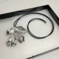Detailaufnahme der silbernen Metallblumen Anhänger Kette mit schwarzem Lederseil. - Blumenstil (Z-2888) / Silber