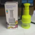 Hand-pressed vegetable chopper in green, ideal for quickly cutting garlic, onions, and kitchen veggies. - Garlic Press / Green