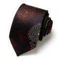 Detailed close-up of a rolled dark men's necktie featuring floral jacquard and red dots. - Black