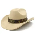 Detailed view of beige suede cowboy hat featuring a brown leather band and bull skull buckle. - Camel