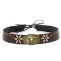 Close-up detail of western cowboy hat band with metal bull skull buckle and flower studs. - 13#