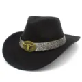 Close-up detail of the vintage black western cowboy hat featuring a striking metallic bull head buckle. - Cowboy Top Hat / Black
