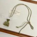 Handmade stone handbag pendant necklace with white lace bow and braided cord detail - Green