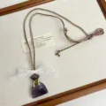Niche design necklace featuring a purple crystal bag pendant and delicate white lace bow. - Purple Bags Z-4432 / Purple