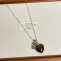 Close-up of the natural stone heart pendant necklace with delicate chain details and beads. - Dark Brown (F-73)
