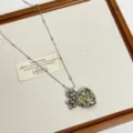 Detailed view of the long chain necklace with natural stone heart pendant and grape charm. - Black Spotted (F-74)