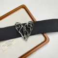 Close-up of a vintage black elastic belt with an ornate silver heart buckle and rhinestones. - Irregular Hollow Heart Buckle Style (H-42) / Silver