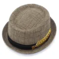 Detail view of men's woven fedora hat featuring classic black band and gold leaf metal accessory. - One Size / Khaki