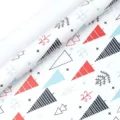 Christmas wrapping paper detail shot, red and blue tree pattern on white gift wrap roll. - Three-color Tree