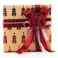 Vintage kraft Christmas wrapping paper roll with red ribbon and rose bow for holiday gifts. - Christmas Series Red Christmas Tree