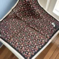 Detailed view of black silk small square scarf featuring vibrant red floral pattern and chic border. - SJ1080-JKF