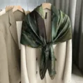 Detailed shot of the vintage printed silk square scarf draped gracefully over a classic coat. - SJ461-JKF