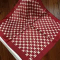 Close-up detail of the red silk square scarf featuring classic monogram pattern design. - SJ1105-JKF