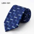 Silk business tie detail showing blue fabric texture and geometric zig zag pattern clearly. - L85H-S01