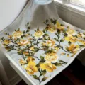 Silk scarf detail showing elegant yellow and white floral pattern on grey background. - SJ1153-JKF