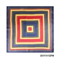 Detail shot of a geometric printed silk square scarf, featuring vibrant concentric square patterns. - Geometric Multi-Layer Frame Print