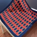 Silk scarf detail showcasing the exquisite red and blue chain pattern and smooth fabric texture. - SJ1169-JKF