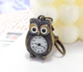 Detailed close-up shot of the antique bronze owl pocket watch dial and keychain clasp hook. - 6*8 Owl Keychain / Bronze