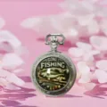 Vintage silver quartz pocket watch with gone fishing dial design, classic necklace accessory. - Fish
