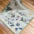 Close-up detail of a mulberry silk square scarf featuring delicate floral and bamboo prints. - SJ1024-JKF